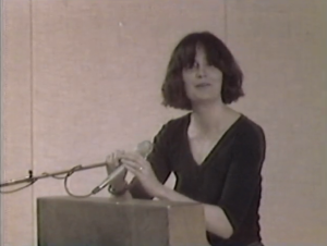 Alice Notley, still from Poetry Center Archives color video recording of her reading, May 3, 1984, at San Francisco State University
