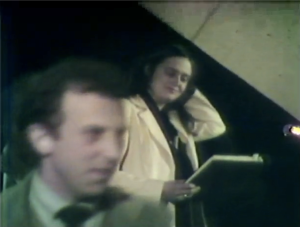 Alice Notley and Lewis Mac Adams, still from Poetry Center Archives color video recording of her reading, February 18, 1976, at San Francisco State University